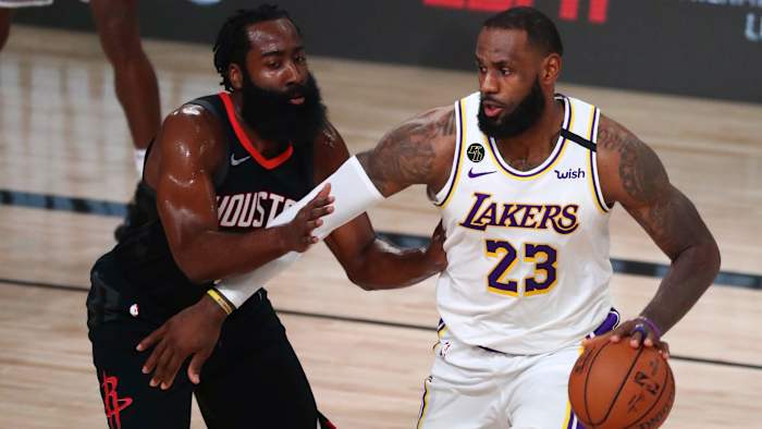 Los Angeles Lakers forward LeBron James (23) dribbles the ball around Houston Rockets guard James Harden (13) in the first half of game five of the second round of the 2020 NBA Playoffs at ESPN Wide W...